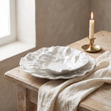 The full Kajabi Plate Collection graduated set on a white oak table