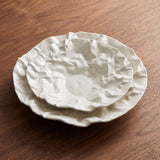 Kajabi Plate Collection — sculptural crumpled white ceramic plates on walnut