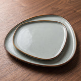 Diamond Dinnerware Set — sculptural celadon plates on a warm wood table