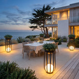 Flower Pot Lamps lighting an oceanfront outdoor dining terrace at dusk