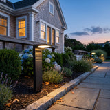 LaVie Solar Light path light glowing among garden planting at dusk