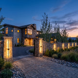 Luminous Line Outdoor Lights mounted on masonry gate piers at dusk