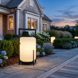Lampara Outdoor Light (Solar) glowing among garden planting at dusk