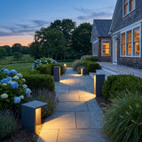 Block Lane Outdoor Solar Light lighting a stone garden path at dusk