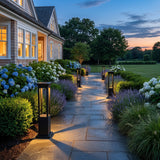 Nimbus Quad Solar Light lighting a stone garden path at dusk