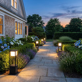 Nimbus Cube Solar Light lighting a stone garden path at dusk