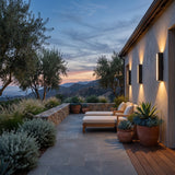 Cascade Wall Light mounted above outdoor lounge seating at dusk