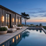 Marble Outdoor Wall Light mounted on a pool house wall, reflected in the water at dusk
