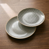 Euclid Plate Collection — sculptural gallery view on a warm wood table