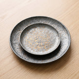 Ritz Speck Plate Collection — sculptural gallery view on a warm wood table