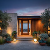 A matched pair of Flower Pot Lamps flanking a modern front entrance at dusk