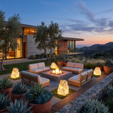 Garden Stone Outdoor Lights around an outdoor fire pit seating area at dusk