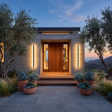 A matched pair of Stripe Lined Wall Lights flanking a front door at dusk
