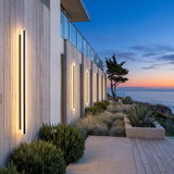 A run of Stripe Lined Wall Lights along a house facade at dusk