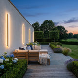 Stripe Lined Wall Lights mounted above outdoor lounge seating at dusk