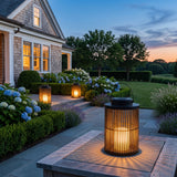 Lantern Sora Weave portable solar lantern glowing on a terrace table at dusk