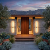 A matched pair of Luminous Line Outdoor Lights flanking a front door at dusk