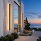 Outdoor Sleek Wall Light mounted on an exterior wall, washing the surface with warm light at dusk