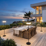 Signature Outdoor Solar Lamp lighting an outdoor dining terrace at dusk