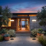 A matched pair of Signature Outdoor Solar Lamp lighting a front entrance at dusk