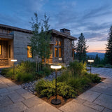 Signature Outdoor Solar Lamp set among garden planting at dusk