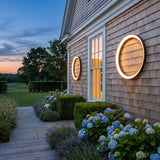 Eclipse Glow Outdoor Light mounted on an exterior wall, washing the surface with warm light at dusk