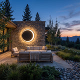 Eclipse Glow Outdoor Light mounted above outdoor lounge seating at dusk