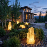 Vibrant Stone Outdoor Light set among garden planting at dusk