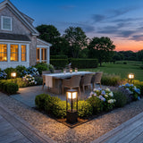 Nimbus Cube Solar Light lighting an outdoor dining terrace at dusk