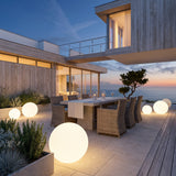 Element Lamp lighting an outdoor dining terrace at dusk