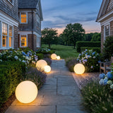 Element Lamp lighting a stone garden path at dusk