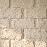 Off-white stone rock wall panel texture, straight-on